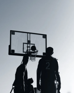 Silhouette of men playing basketball. 