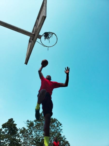 man scoring a basket from a low angle