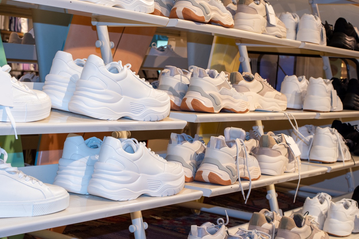 A side view of shelves with many sneakers