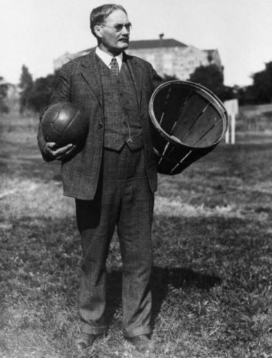 James Naismith carrying a soccer ball and a peach basket