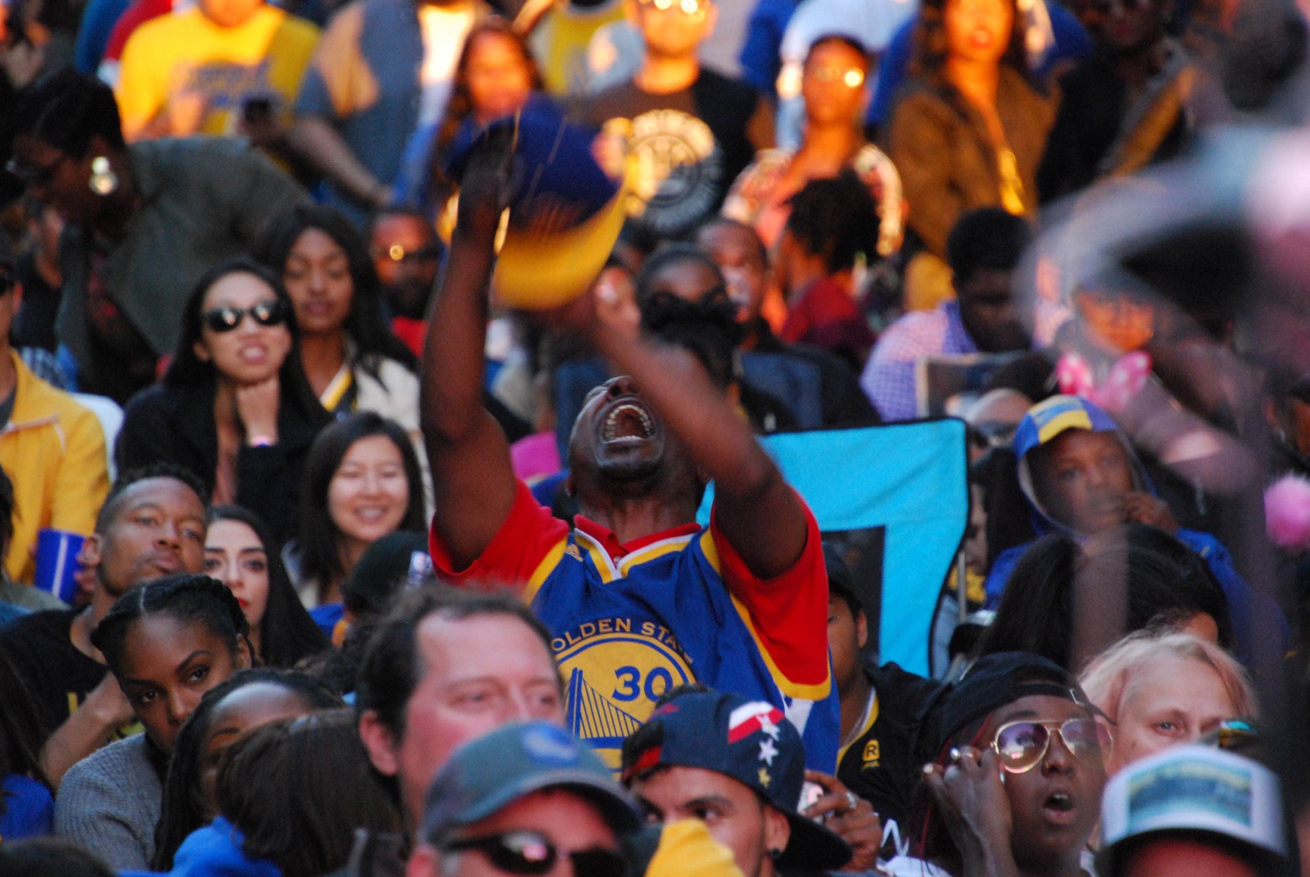A man cheers for the Golden State Warriors at a watch party in downtown Oakland as the team approached a four-game sweep over the Cleveland Cavaliers to win the 2018 NBA Finals.