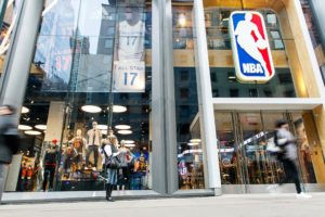 New York, February 21, 2017 People standing and walking by the front window of the NBA store in Manhattan..jpg