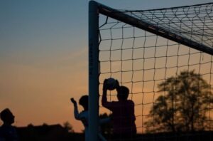 Silhouette of a goalkeeper catching the ball