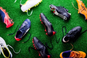 different football cleats on the field