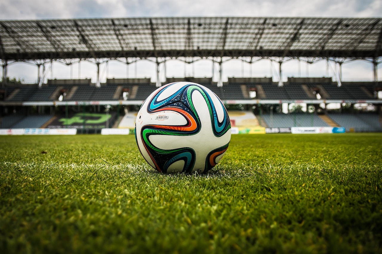 multicolored soccer ball on a green field