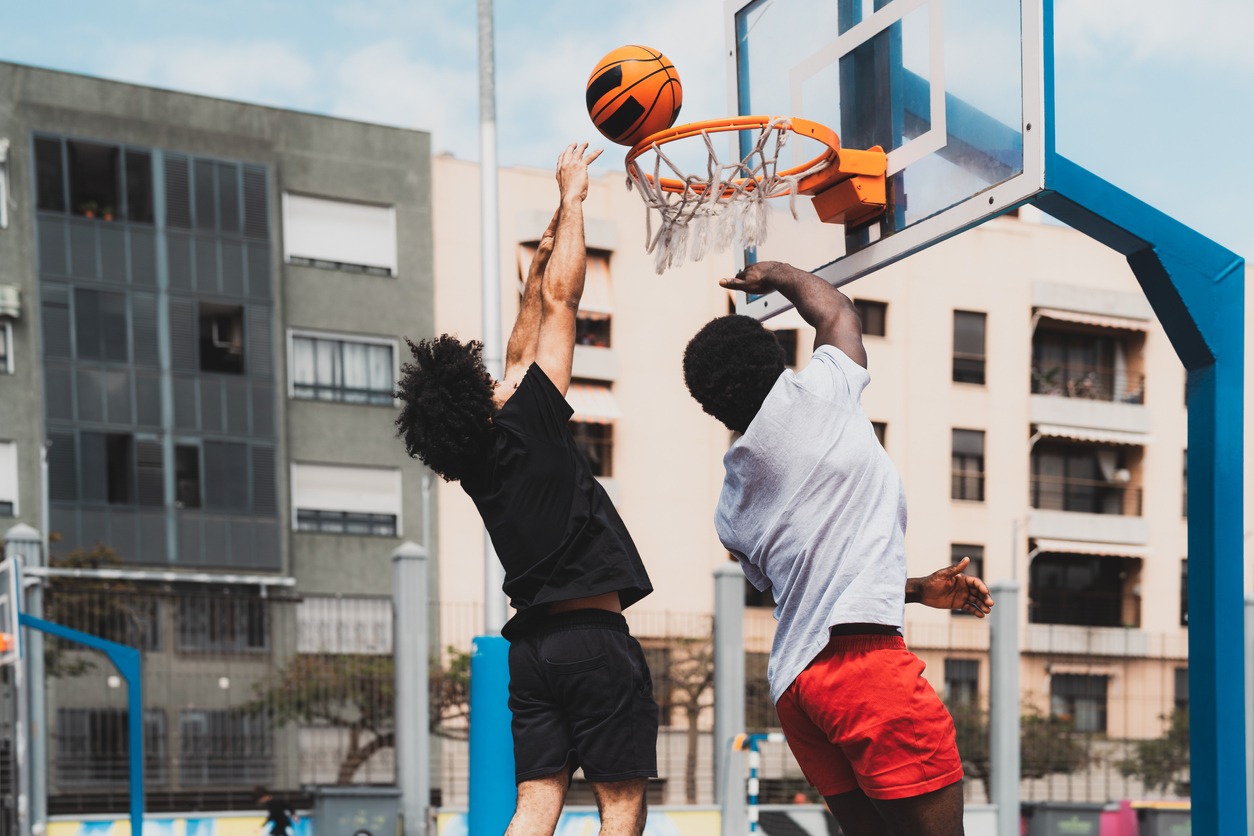 men playing basketball outdoors