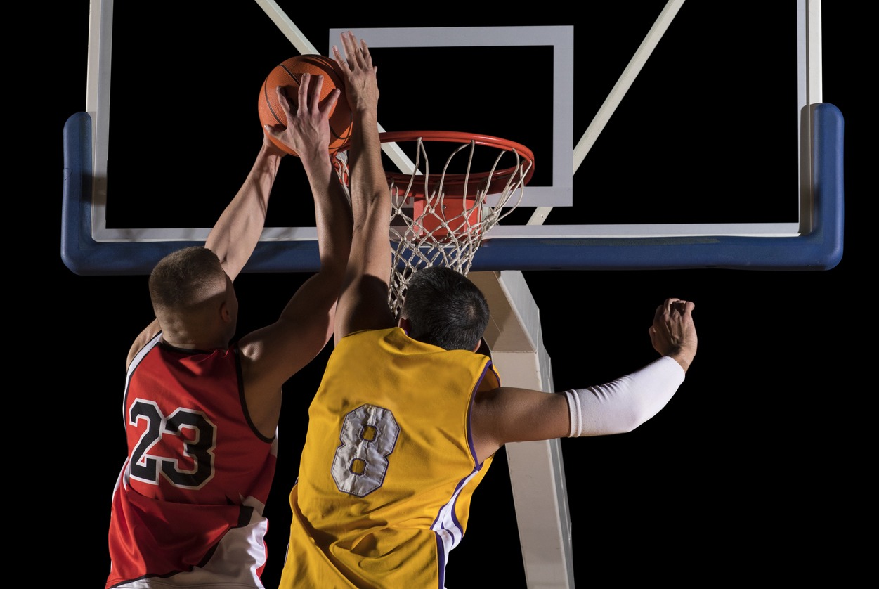 two basketball players in action